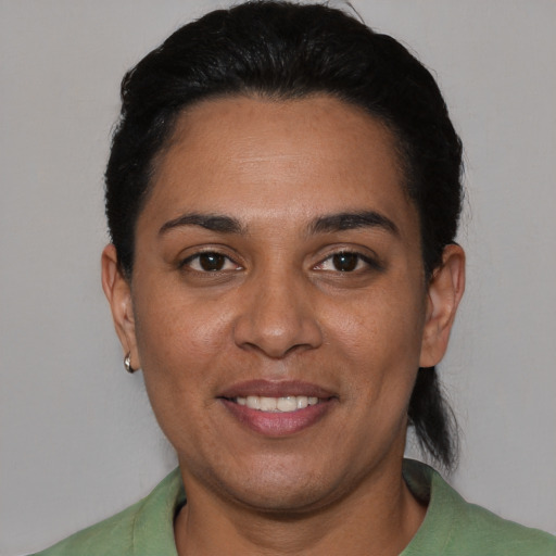 Joyful white adult female with short  black hair and brown eyes