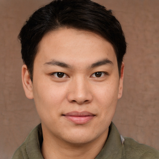 Joyful asian young-adult male with short  brown hair and brown eyes