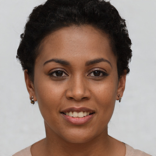 Joyful black young-adult female with short  brown hair and brown eyes