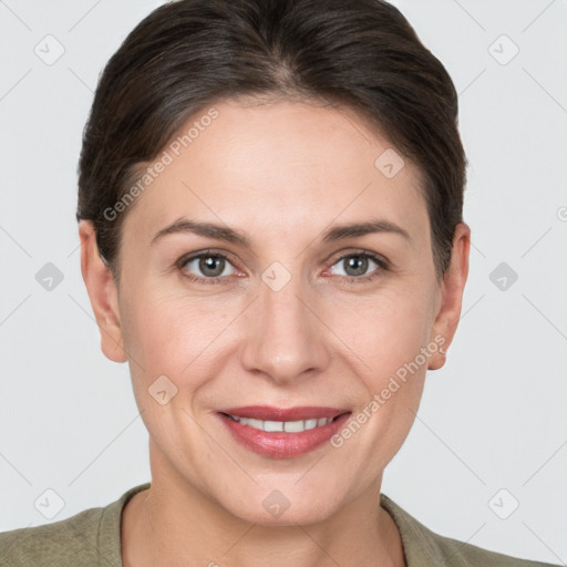 Joyful white adult female with short  brown hair and grey eyes