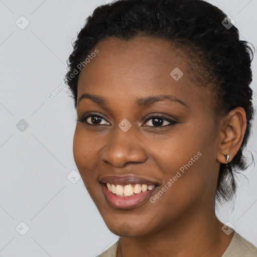 Joyful black young-adult female with short  black hair and brown eyes