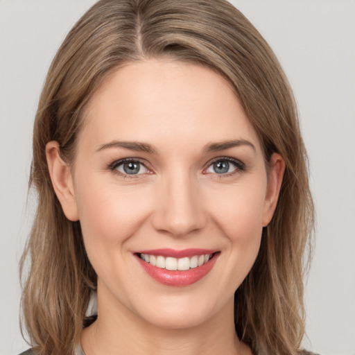 Joyful white young-adult female with medium  brown hair and grey eyes