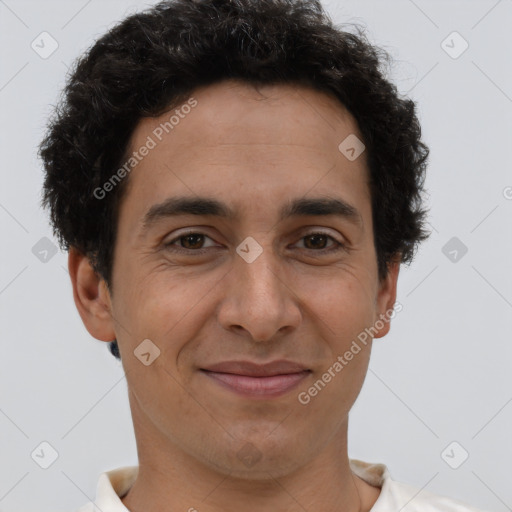 Joyful latino young-adult male with short  brown hair and brown eyes