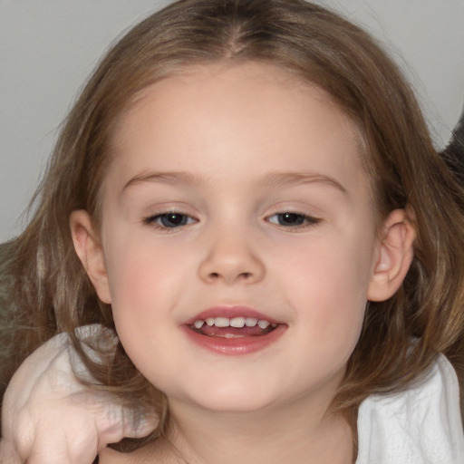 Joyful white child female with medium  brown hair and brown eyes