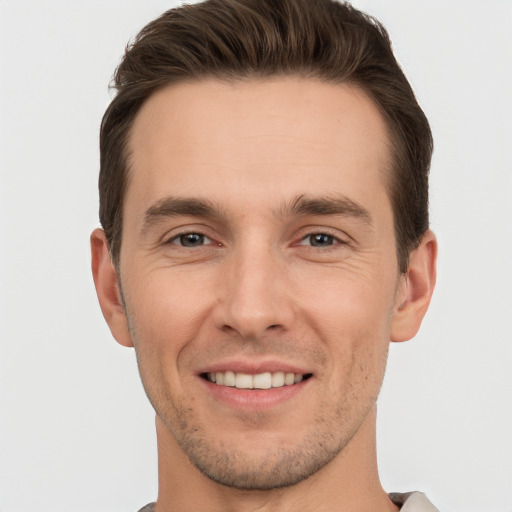 Joyful white young-adult male with short  brown hair and brown eyes