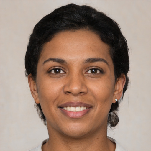 Joyful latino young-adult female with short  black hair and brown eyes