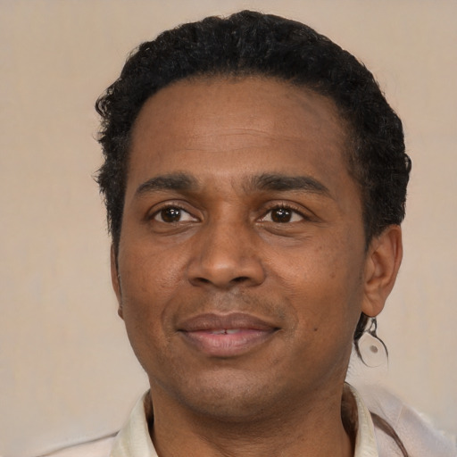 Joyful latino adult male with short  black hair and brown eyes