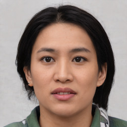 Joyful asian young-adult female with medium  black hair and brown eyes