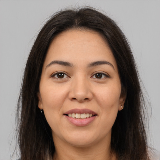 Joyful latino young-adult female with long  brown hair and brown eyes