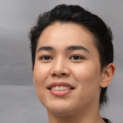 Joyful asian young-adult female with short  black hair and brown eyes