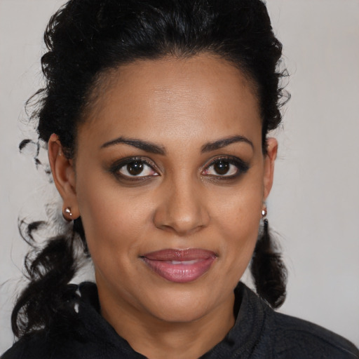 Joyful black young-adult female with medium  brown hair and brown eyes