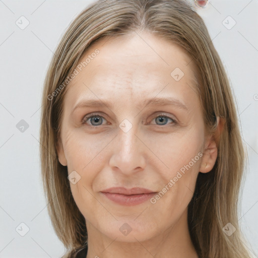 Joyful white adult female with long  brown hair and grey eyes