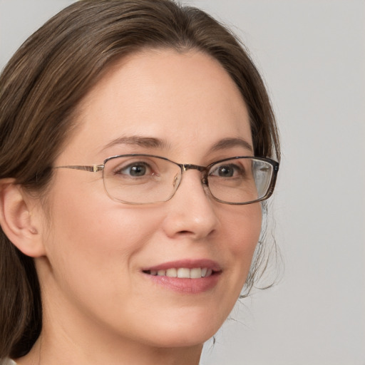 Joyful white adult female with medium  brown hair and grey eyes