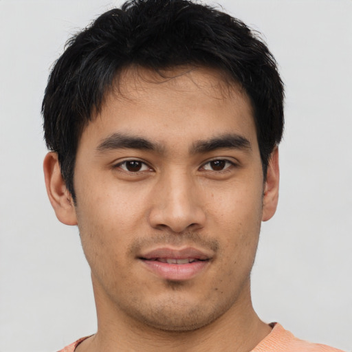 Joyful asian young-adult male with short  brown hair and brown eyes