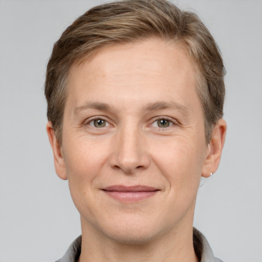 Joyful white adult female with short  brown hair and grey eyes