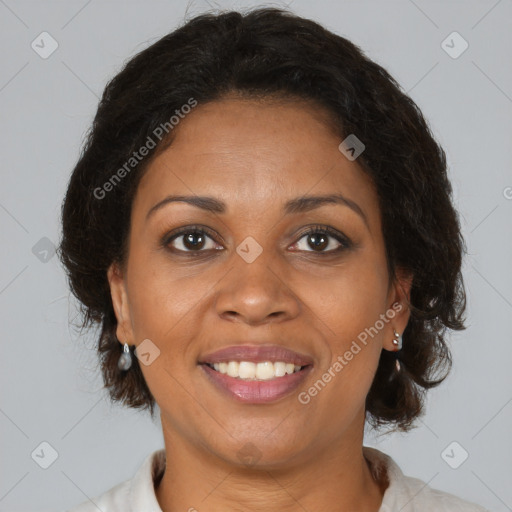 Joyful black adult female with medium  brown hair and brown eyes