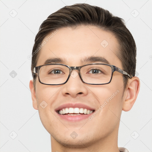 Joyful white young-adult male with short  brown hair and brown eyes