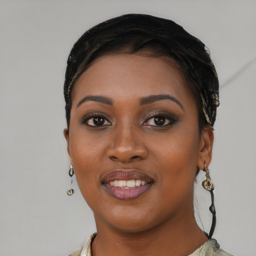 Joyful black young-adult female with short  black hair and brown eyes