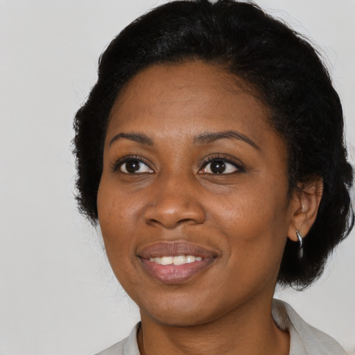 Joyful latino adult female with medium  black hair and brown eyes