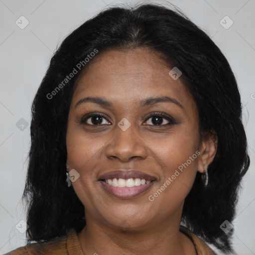 Joyful black young-adult female with long  brown hair and brown eyes