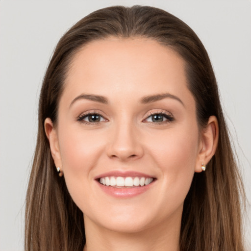 Joyful white young-adult female with long  brown hair and grey eyes