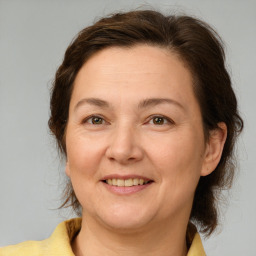 Joyful white adult female with medium  brown hair and brown eyes