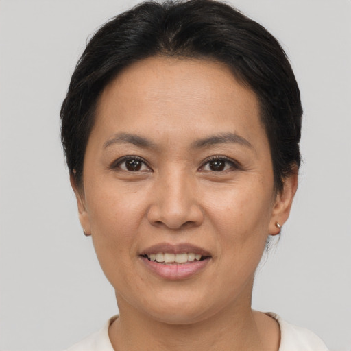 Joyful asian adult female with short  brown hair and brown eyes