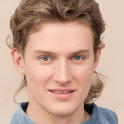 Joyful white young-adult male with short  brown hair and blue eyes