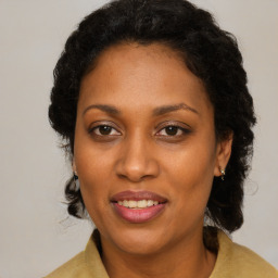 Joyful black adult female with medium  brown hair and brown eyes