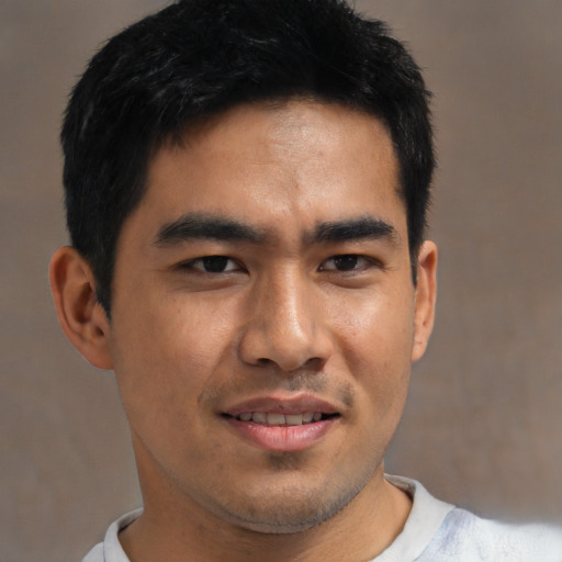 Joyful asian young-adult male with short  brown hair and brown eyes