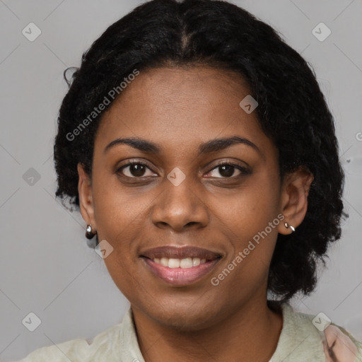 Joyful black young-adult female with short  black hair and brown eyes