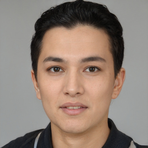 Joyful white young-adult male with short  black hair and brown eyes