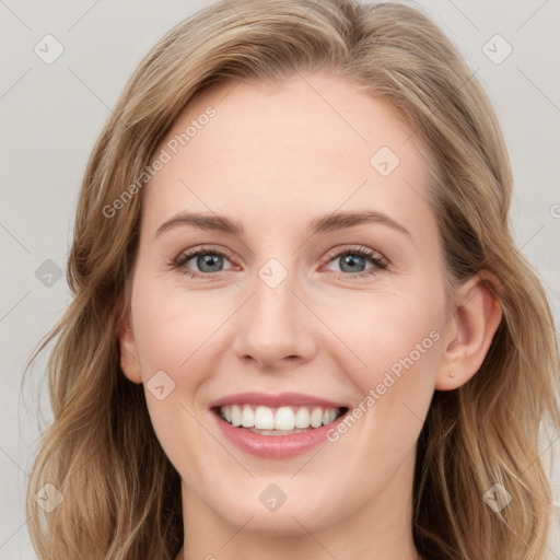 Joyful white young-adult female with long  brown hair and blue eyes