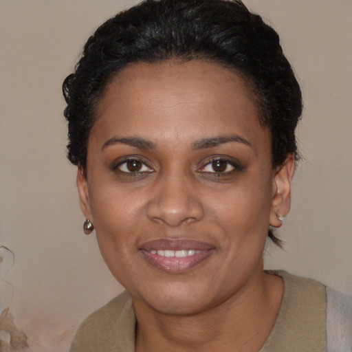 Joyful black young-adult female with short  black hair and brown eyes