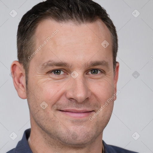 Joyful white adult male with short  brown hair and brown eyes