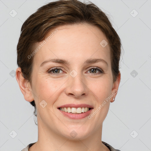 Joyful white young-adult female with short  brown hair and grey eyes