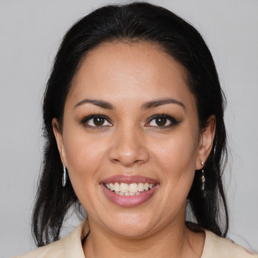 Joyful latino young-adult female with medium  brown hair and brown eyes