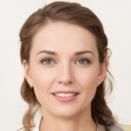 Joyful white young-adult female with medium  brown hair and blue eyes