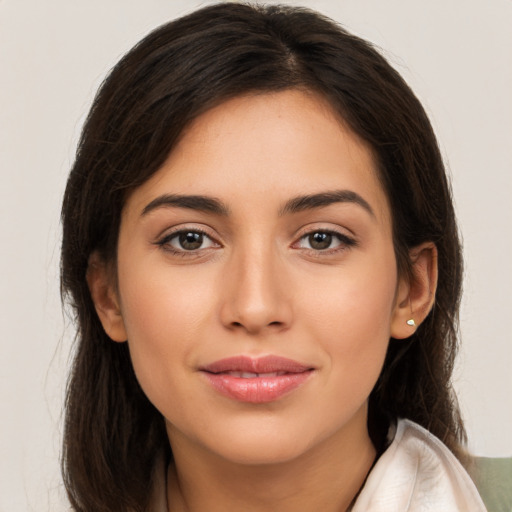 Joyful white young-adult female with long  brown hair and brown eyes