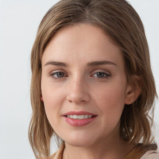 Joyful white young-adult female with medium  brown hair and grey eyes