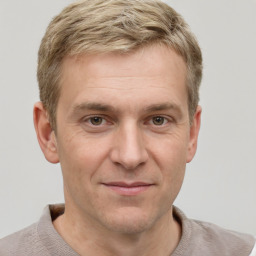 Joyful white adult male with short  brown hair and grey eyes