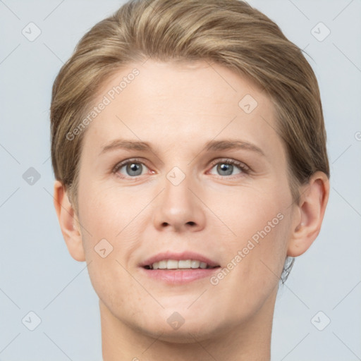 Joyful white young-adult female with short  brown hair and grey eyes