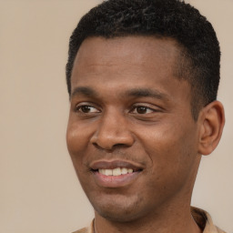 Joyful black young-adult male with short  black hair and brown eyes