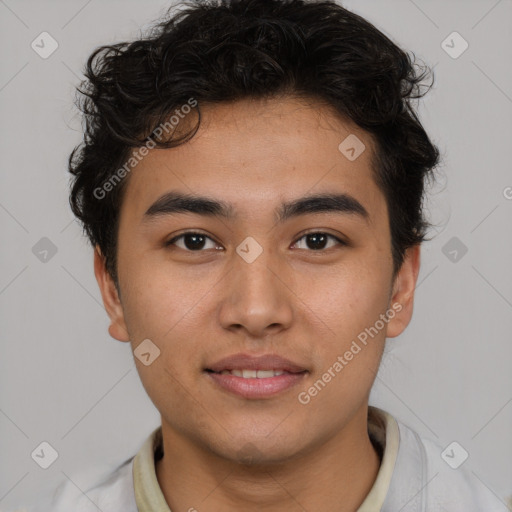 Joyful latino young-adult male with short  brown hair and brown eyes