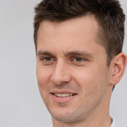 Joyful white adult male with short  brown hair and brown eyes