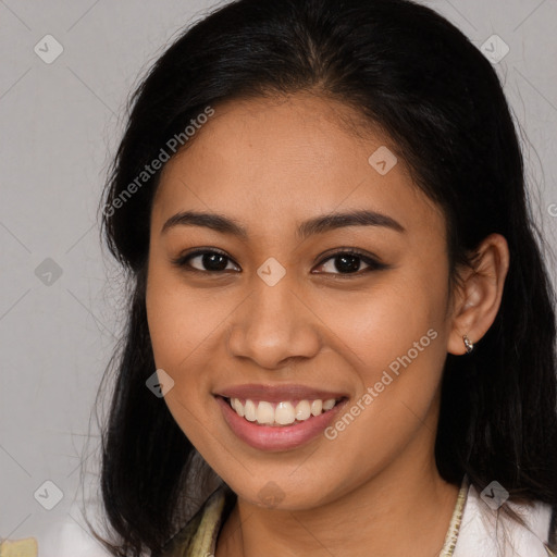 Joyful latino young-adult female with long  brown hair and brown eyes