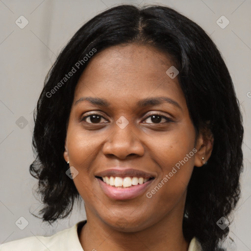 Joyful black young-adult female with medium  black hair and brown eyes