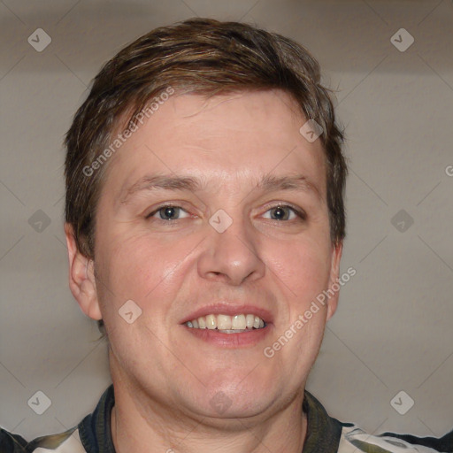 Joyful white adult male with short  brown hair and grey eyes