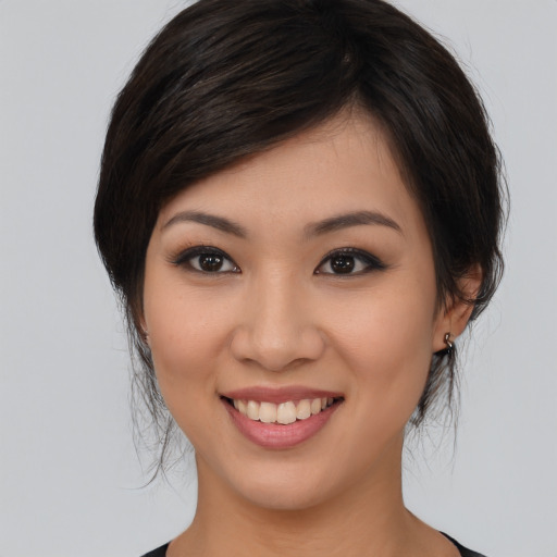 Joyful asian young-adult female with medium  brown hair and brown eyes