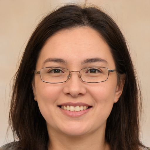 Joyful white adult female with long  brown hair and brown eyes